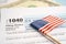 Tax Return form 1040 with USA America flag and dollar banknote, U.S. Individual Income