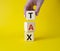 Tax symbol. Wooden cubes with word Tax. Businessman hand. Beautiful yellow background. Business and Finace and Tax concept. Copy