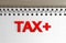 Tax Text And Note Pad On Wood Desk Focused Image