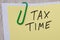 Tax time written on yellow note