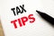 Tax Tips. Business concept for Taxpayer Assistance Refund Reimbursement written on notebook with copy space on book background wit