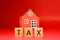 Tax word with blur home background - Red pattern of Business and Planning cost investment concept - Calculate Reduce Taxes or Taxe