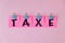 Taxe text on a pink sticker and on pink background