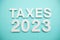 Taxes 2023 alphabet letters on blue background