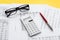 Taxes calculation concept. Financial documents, calculator, glasses on yellow background