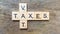 Taxes print text on wood square block