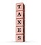 Taxes Word Sign. Vertical Stack of Rose Gold Metallic Toy Blocks