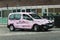 Taxi cab with Pretty Little Thing Fashion Clothing Advertisement wrap in street