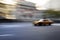 Taxi cab speeding down street in a blur