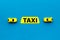 Taxi concept. Yellow service sign text taxi near car toy on blue background top view space for text