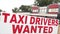 taxi drivers wanted sign in red capital letters writing text with buildings..