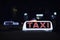 Taxi light symbol in the city night