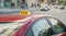 Taxi parked on the sidewalk of a large street with large traffic jams, the car reflects the lights of the evening city