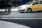A taxi at a pedestrian crossing misses a person