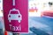 Taxi pick-up point sign in pink color.