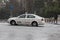 A taxi rides on the road when heavy hail falls