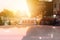 Taxi sign on the roof of taxi cab on the busy street over yellow orange warming sunset background.