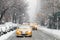 Taxis drive down a snow covered 5th Avenue during a winter storm in New York City