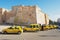 Taxis wait for passengers in from of the medina wall in Sfax, Tunisia.