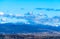 Tbilisi cityscape with snowy mountains and puffy clouds