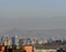 Tbilisi cityscape with snowy mountains and puffy clouds