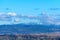 Tbilisi cityscape with snowy mountains and puffy clouds