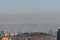 Tbilisi cityscape with snowy mountains and puffy clouds