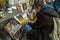 Tbilisi, Georgia, 15 December 2019 -  young man selecting old vinyl discs in outdoor flea market on the Dry bridge