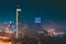 Tbilisi, Georgia. Construction Development Of Modern Architecture On Background Of Urban Night Cityscape. Evening Night