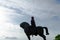 Tbilisi, Georgia, JULY, 2019: Stone equestrian statue rider with sword and raised hand on the river Bank