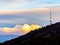 Tbilisi TV Tower with dramatic  puffy pastel clouds at sunset.
