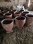 TClay pots that have just been made by craftsmen wait to dry and are then fired in a furnace