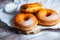 TDelicious donuts with powdered sugar on wooden table