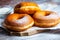 TDelicious donuts with powdered sugar on wooden table