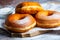 TDelicious donuts with powdered sugar on wooden table