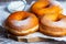 TDelicious donuts with powdered sugar on wooden table