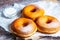 TDelicious donuts with powdered sugar on wooden table