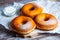 TDelicious donuts with powdered sugar on wooden table