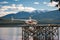 Te Anau, New Zealand - July 2018: Tranquil scene, helicopter on a landing platform over a calm lake with mountain background