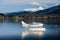 Te Anau, New Zealand - July 2018: Tranquil scene, sea plane at anchor on a clear, calm lake with snow capped mountain background