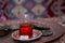 Tea in Azerbaijani traditional armudu pear-shaped glass . Azerbaijan black tea .white sugar cubes . Black turkish tea in pear
