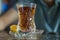 Tea in Azerbaijani traditional armudu pear-shaped glass . Azerbaijan black tea .white sugar cubes . Black turkish tea in pear