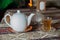 Tea in Azerbaijani traditional armudu pear-shaped glass . Azerbaijan black tea .white sugar cubes . White kettle and sugar bowl .