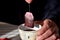 Tea bag with a cup of tea in hands at the man/ Closeup still life food photography/ Fresh red herbal cup of tea