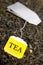 Tea bag over dried tea leaves background