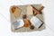 Tea bags, anise, cinnamon sticks and slices of dried tangerines. Lying on a piece of linen. Against the background of white