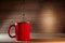 Tea being poured into red tea cup