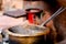 Tea boiling in a dirty open saucepan on a roadside stall in indian city