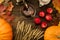 Tea c still life with samovar, apples, ripe orange pumpkins, maple leaves, wheat on wooden background.