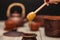 Tea ceremony, tea party. Clay dishes. Honey flows from a wooden